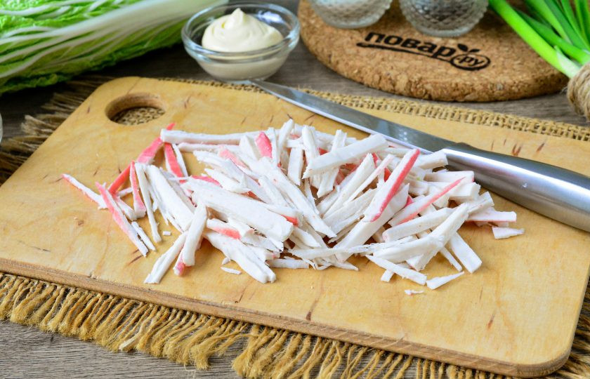 1. Этап. Салат с сыром, крабовыми палочками и пекинской капустой: Крабовые палочки почистите от упаковочной пленки, после чего палочки нарежьте соломкой.