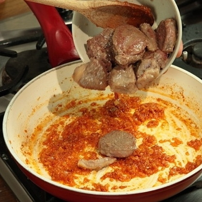 1. Этап. Баранина тушеная в соусе: Мясо извлекаем из сковороды. В оставшемся в сковороде жиру обжариваем лук с паприкой. Через 2-3 минуты, когда лук слегка поджарится, возвращаем в сковороду мясо. Обжариваем вместе еще 1 минуту.