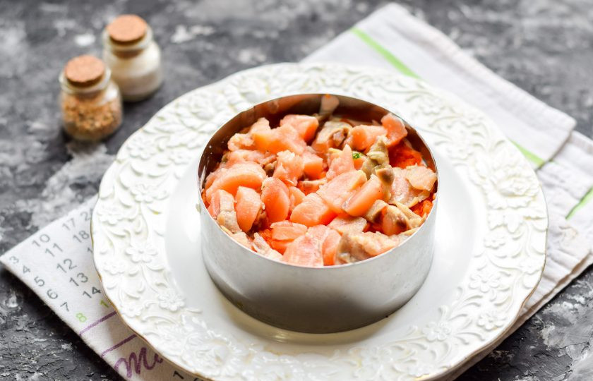 1. Этап. Салат Мимоза с красной рыбой: Семгу нарежьте небольшими кусочками, выложите поверх моркови.
