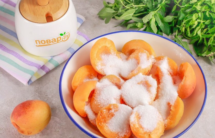 1. Этап. Абрикосы с сахаром на зиму: Засыпьте половинки абрикосов сахаром и оставьте на 20-30 минут, чтобы они выделили сок.