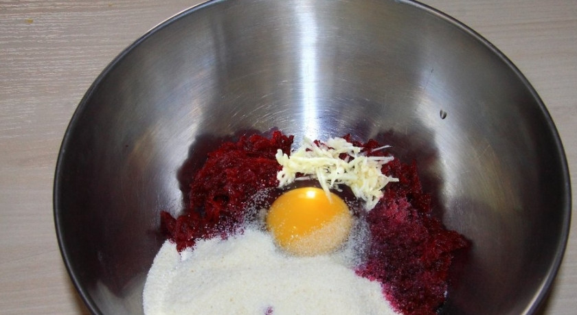 1. Этап. Оладьи из свеклы: 2. Чистим чеснок и натираем его на терке, добавляем в миску к свекле, туда же вбиваем одно яйцо, кладем манную крупу и соль.