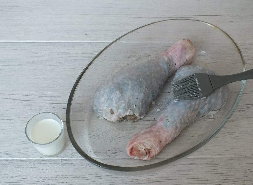 1. Этап. Фаршированная голень индейки в духовке: Переложите голени в форму смазанную маслом. Смажьте сливками.