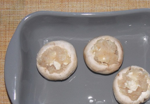 1. Этап. Фаршированные шампиньоны с фаршем и сыром: В форму для запекания влить растительное масло. Выложить шампиньоны. Запекать при 180С, примерно 25 минут.