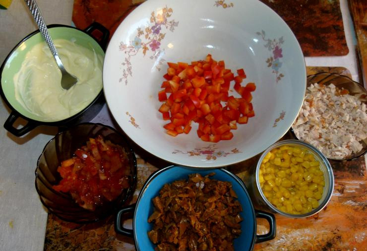 1. Этап. Салат с лисичками под сметаной: Овощи промываем, помидор и перец нарезаем кубиками, куриную грудку режем на небольшие кусочки, с кукурузы сливам воду. Грибы, если они крупные, также следует порезать помельче.