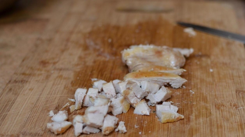 1. Этап. Салат с курицей и опятами: Обжаренную курицу нарезаем небольшими кубиками и складываем в салатницу.