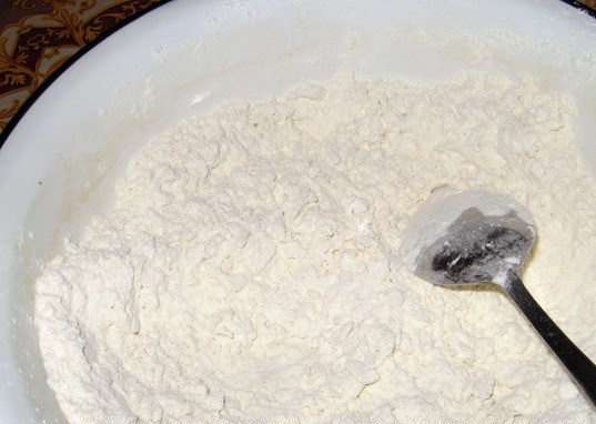 1. Этап. Тесто для пельменей на сметане: Перекладываем сметану к мучной смеси и перемешиваем все.