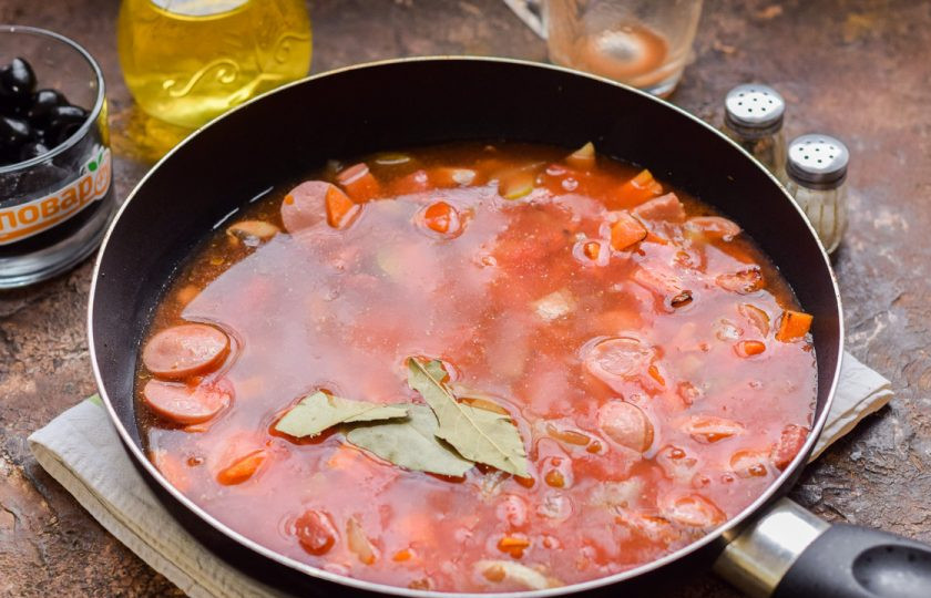 1. Этап. Солянка Барская: Влейте в сковороду бульон. Готовьте под крышкой 35 минут.