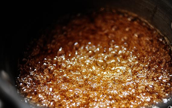 1. Этап. Шоколадные пирожные в глазури: 4. Приготовить глазурь. В небольшой кастрюльке на слабом огне нагреть сливки. Не кипятить. В отдельную кастрюлю добавить сахар и воду. Не мешать. На среднем огне довести до кипения. Варить, пока смесь не станет янтарного цвета. Снять с огня.