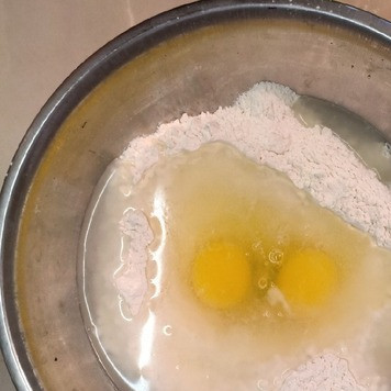 1. Этап. Вареники с мясом и картофелем: 300г муки высыпать в миску, сделать в муке углубление, разбить в него яйца, налить воду и посолить.