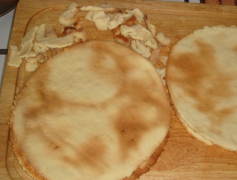 1. Этап. Торт низкокалорийный: Духовку разогрейте до отметки 200 градусов. Получившиеся круглые коржи выложите на пергамент для запекания или же на хорошенько смазанный растительным маслом противень. Наколите их вилкой в нескольких местах и выпекайте каждый по десять минут, выложив к коржам остатки теста.