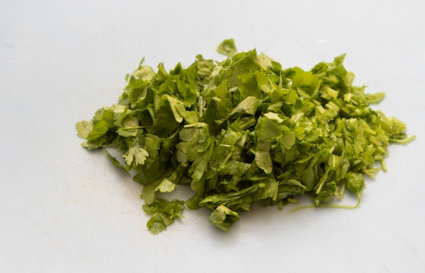 1. Этап. Мусака классическая: Нарежьте петрушку и добавьте ее к мясу за минутку до выключения огня.