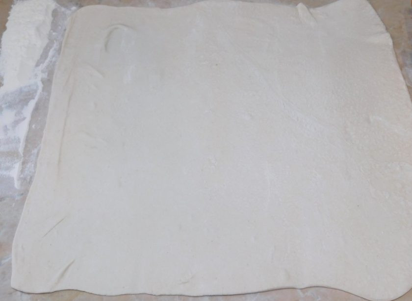 1. Этап. Рулет из слоеного теста с сыром: Слоеное тесто раскатайте в прямоугольный пласт толщиной примерно 3-4 мм.