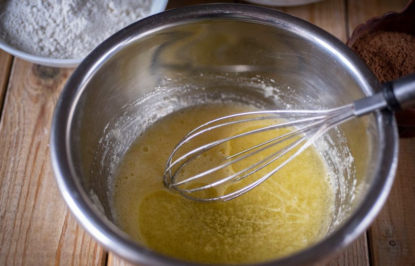 1. Этап. Пирог на кефире с творогом: Добавьте растительное масло и активно перемешайте все венчиком.