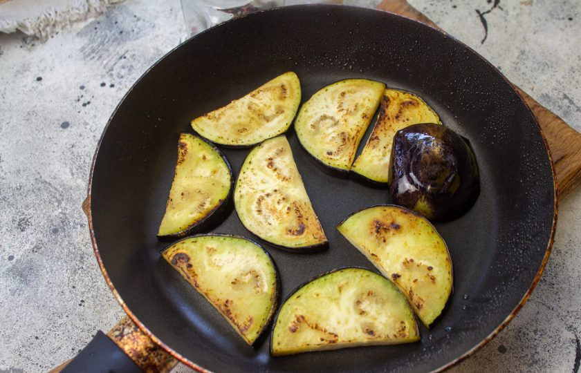 1. Этап. Запеканка из баклажанов по-гречески: Баклажан нарежьте кружочками и обжарьте в минимальном количестве масла с двух сторон по минутке.