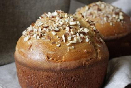 1. Этап. Сладкий хлеб с апельсином: 4. Можно взять одну большую форму или две маленькие. Смазать маслом. Положить в форму тесто и отложить на 1 час. Поставить тесто нужно в теплое место. Когда тесто увеличится в два раза, смазать сверху яйцом и посыпать орехи. Печется хлеб около 50 минут при температуре 180 градусов.