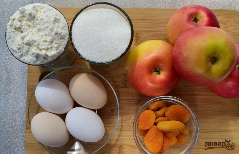 1. Этап. Шарлотка с курагой и яблоками: Подготовьте необходимые продукты. Яблоки вымойте, курагу замочите в кипятке на 20 минут.