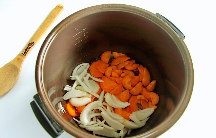 1. Этап. Индейка с грибами в мультиварке: Сверху положите нарезанный перьями лук и нарезанную крупно морковь.