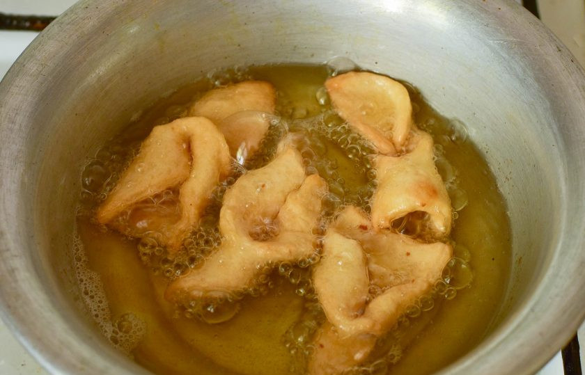 1. Этап. Хворост на минералке: Выверните один край через дырочку. Разогрейте растительное масло, выложите хворост и жарьте его до румяного цвета.