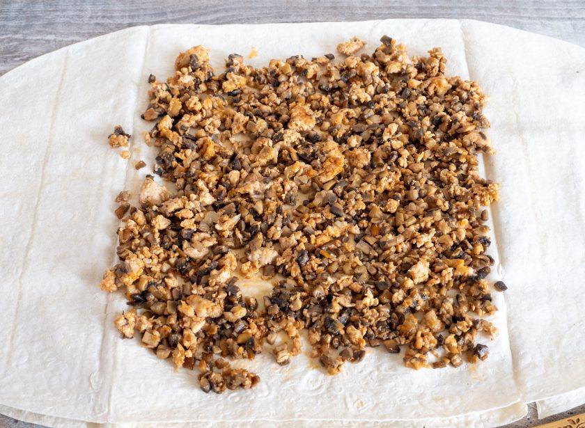 1. Этап. Лаваш с фаршем и грибами: Два лаваша сложите вместе, чтобы рулет не порвался и выложите начинку со сковороды. Оставляйте немного места сверху и снизу.