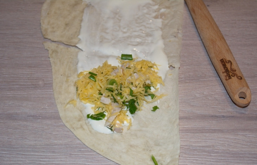 1. Этап. Рулетики из лаваша с сыром: Лист лаваша нарезаем на широкие полоски. Полоску лаваша смазать сметаной. Выложить часть начинки.