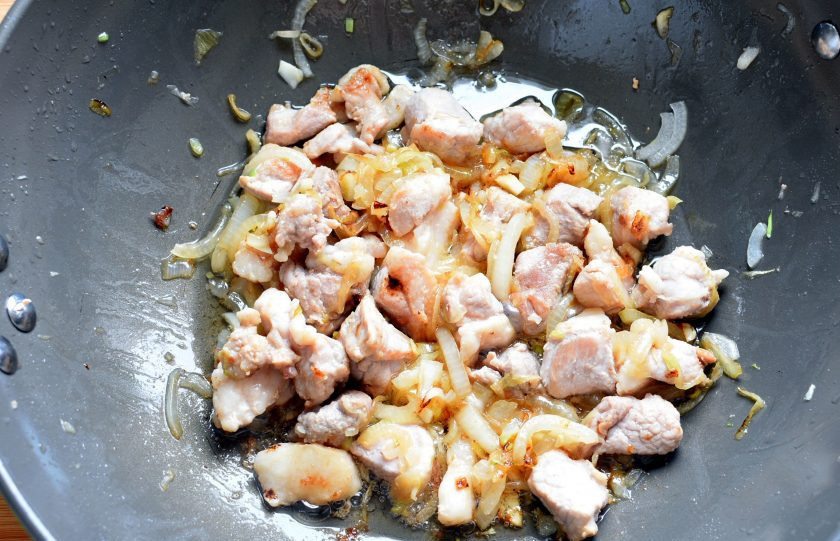 1. Этап. Рагу из свинины с баклажанами: Свинину нарежьте средними кубиками и обжарьте с луком до золотистой корочки.