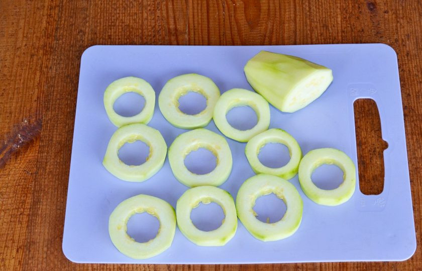 1. Этап. Кабачки в ананасовом соке на зиму: Очищенный кабачок нарежьте кружочками. Вырежьте по центру мякоть, чтобы получились кольца.