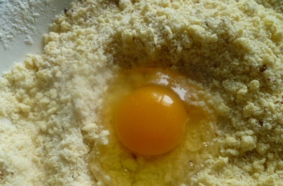 1. Этап. Печенье желейное: 4. Орехи измельчаю в крошку (с помощью скалки и блендера) и добавляю в тесто, также вбиваю куриное яйцо.