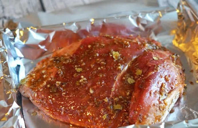 1. Этап. Маринад для свинины в фольге: Смешиваем все сухие ингредиенты с медом, ромом, соком и уксусом. Перекладываем мясо на большой кусок фольги. Обмазываем свинину со всех сторон маринадом.
