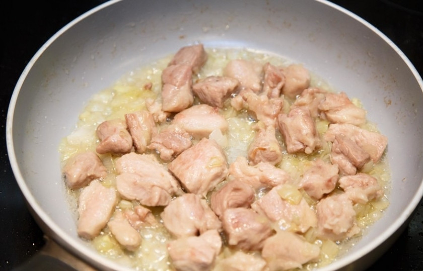 1. Этап. Карри со свининой: Репчатый лук очистите и нарежьте мелко. Нам нужно около 150 грамм лука. В сковороду с растительным маслом положите свинину и начните обжаривать. Через 5 минут добавьте туда лук. Посолите по вкусу.