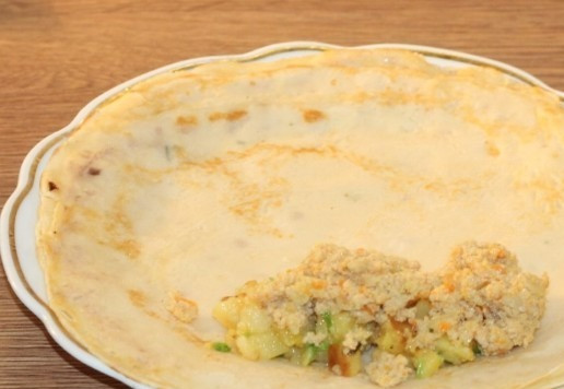 1. Этап. Блинные конвертики с индейкой и картофелем: 15. На верхний край блинчика кладем начинку: картофель и мясной фарш. Заворачиваем края и сворачиваем блинчик трубочкой.