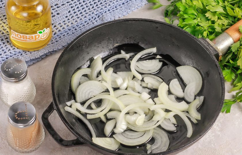 1. Этап. Жареные грибы: Нарежьте репчатый лук полукольцами. Прогрейте в сковороде растительное масло и обжарьте в нем луковую нарезку примерно 3-4 минуты.