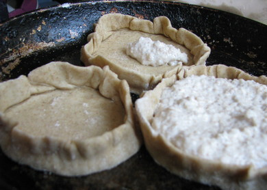 1. Этап. Бурятские шаньги: 5. Выложите в центр начинку, а затем аккуратно сформируйте бортики. Смажьте сметаной, выложите на противень, застеленный пергаментом или смазанный маслом. Отправьте в разогретую духовку. Выпекайте бурятские шаньги в домашних условиях до румяности.