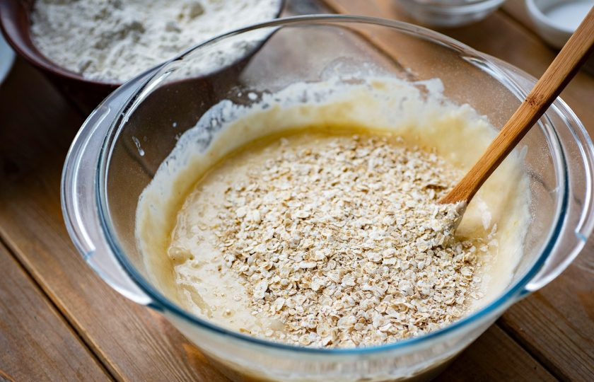 1. Этап. Булочки с овсяными хлопьями: Добавьте овсяные хлопья, соль и вмешайте эти ингредиенты ложкой.