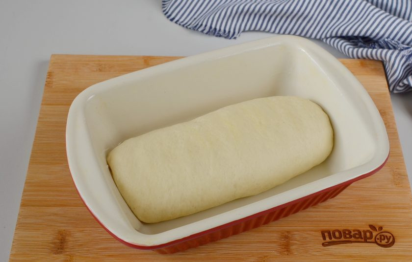 1. Этап. Заварной хлеб: Достаньте тесто из миски, на столе помесите его руками пару минут. Сформируйте булочку хлеба. Смажьте растительным маслом керамическую форму (в ней лучше всего выпекать хлеб) и выложите тесто. Накройте пленкой или полотенцем, оставьте в тепле на 30-40 минут. Минут за 10-15 включите духовку, пусть разогревается.