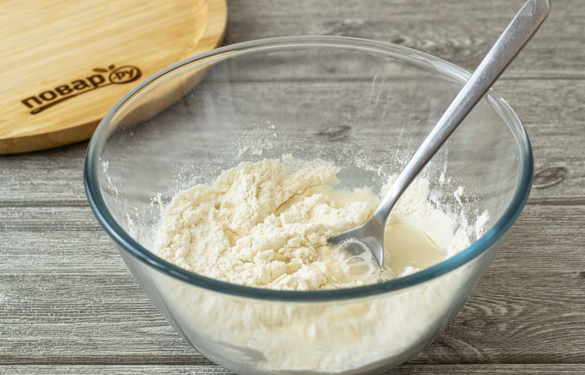 1. Этап. Пельмени с редькой: Для теста в глубокую миску просейте муку, добавьте щепотку соли и перемешайте. Затем постепенно вливайте воду, смешайте до однородности.