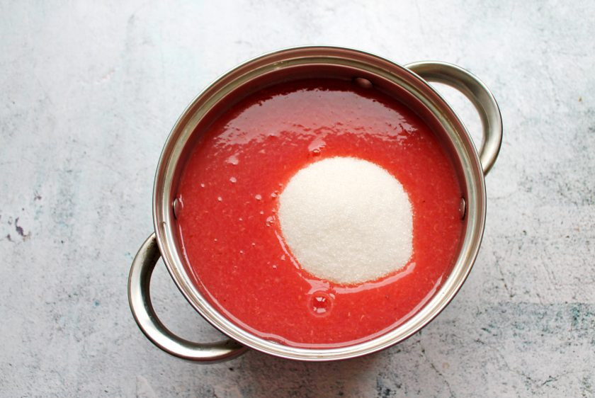 1. Этап. Варенье из малины и красной смородины: Протрите смородину через сито в кастрюлю с толстым дном и всыпьте сахар.