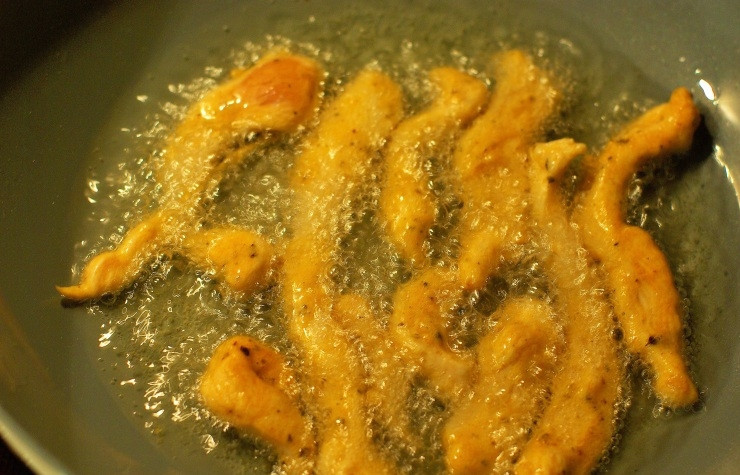 1. Этап. Куриные палочки в панировке: После того, как курица хорошо промариновалась, на печку на сильный огонь ставим сковородку и наливаем в нее достаточно большое количество масла. Обжариваем каждый кусочек с двух сторон до аппетитной корочки (довольно быстро).