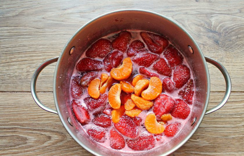 1. Этап. Варенье из клубники с мандаринами: Мандарины очистите от кожуры и белых волокон, если есть зернышки, удалите. Выложите дольки мандарина в варенье.