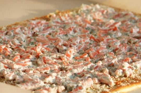 1. Этап. Рулет с семгой и зеленью: Рыбную начинку равномерно распределяем по всему коржу.