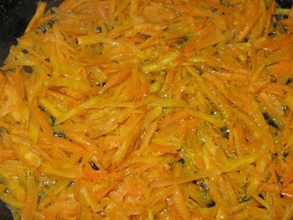 1. Этап. Кабачковая икра с мукой: Теперь подготавливаем для наших кабачков морковь. Хорошенько промываем её под водой, счищаем верхний слой и трём овощ на крупной тёрке. Забрасываем её на разогретую с маслом сковородку и слегка жарим в течение 5 минут, пока не начнёт отдавать сок и не станет золотистой.