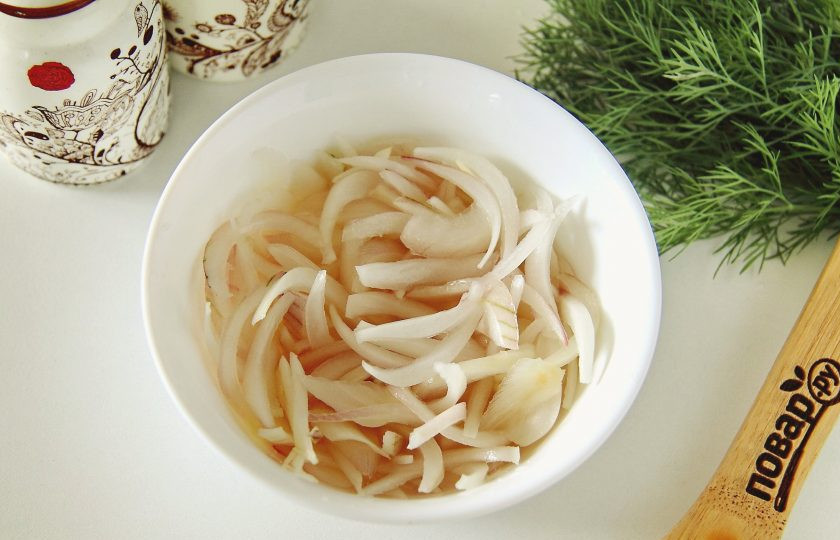 1. Этап. Салат с куриной грудкой и маринованным луком: Лук нарежьте перьями или полукольцами, добавьте соль, сахар и уксус. Воду доведите до кипения, добавьте в миску с луком, перемешайте и оставьте на 20 минут. Затем воду полностью слейте.