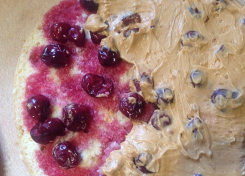 1. Этап. Бисквитный торт с масляным кремом: Смазываем корж с ягодами половиной от общего количества крема.