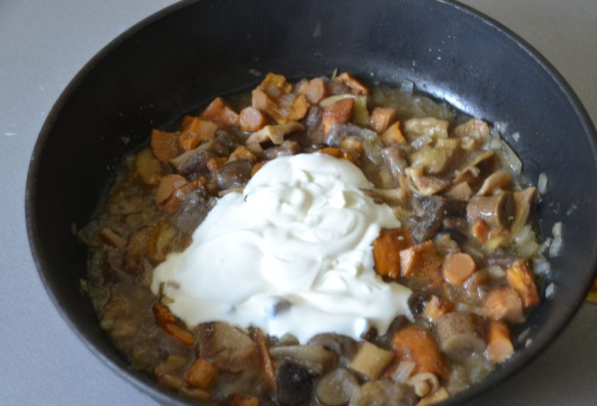 1. Этап. Картошка с лесными грибами: Добавьте к грибам 2 ст. ложки сметаны, размешайте и потушите еще 10-15 минут под крышкой.