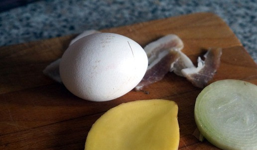 1. Этап. Бенедикт по-сибирски: Клубень картофеля тщательно обмыть, затем, не снимая кожуры, вырезать из середины ломтик толщиной примерно 0,5-0,7 см. Вдоль или поперек – зависит от толщины картофелины. У меня получилось вдоль. Так же поступить с луковицей, но верхнюю шелуху убрать. С куска соленого сала срезать очень тонко пару-тройку ломтиков, убрав кожуру. Вот так все выглядит в итоге.