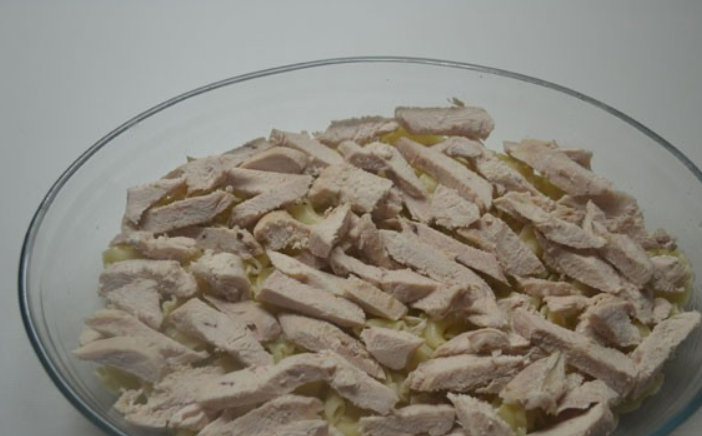 1. Этап. Запеканка под соусом бешамель: Теперь кладем сваренное куриное филе, которое нужно порезать небольшими кусочками.