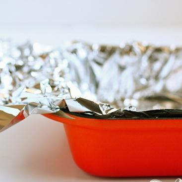 1. Этап. Пирожные с шоколадом и безе: 1. Разогреть духовку до 175 градусов. Выстелить форму алюминиевой фольгой, делая навесы по краям, чтобы потом было удобнее удалить фольгу. Сбрызнуть фольгу маслом.