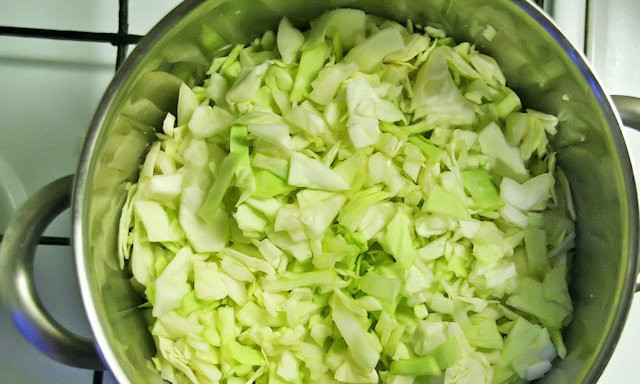 1. Этап. Cолянка тушеная: Нарубите среднего размера кусочками капусту. Уложите её в кастрюлю и разомните руками, чтобы пошёл сок.