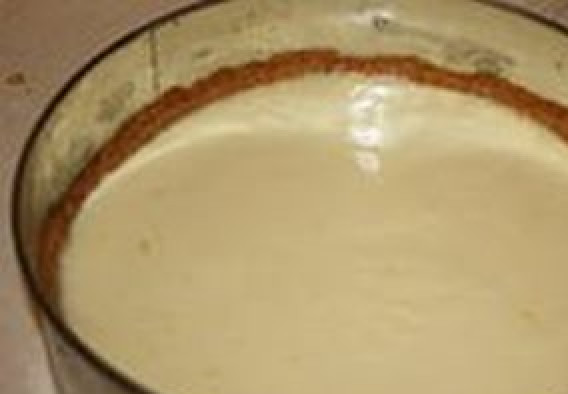 1. Этап. Чизкейк со сгущенкой без выпечки: Желатин залейте на 10 минут холодной водой, а затем растворите его на водной бане. Сметану смешайте со сгущенным молоком, влейте желатин и тщательно перемешайте. Влейте эту смесь в форму с печеньем и поставьте в холодильник для застывания на 2-3 часа.