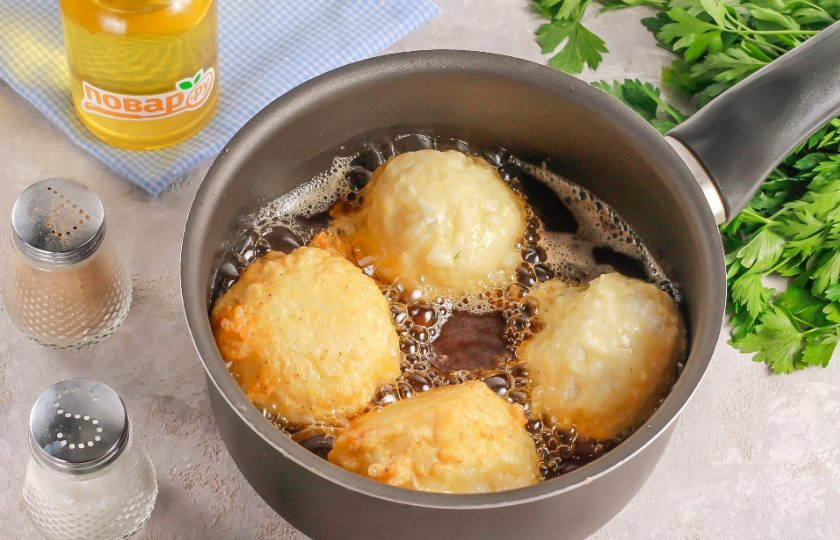 1. Этап. Рисовые шарики с креветками и творожным сыром: Прогрейте масло в ковше или в сковороде с высокими бортиками до кипения. Лишь после этого выложите в него заготовки в кляре и убавьте нагрев до умеренного. Обжарьте рисовые шарики примерно 2-4 минуты, переворачивая их из стороны в сторону для равномерного подрумянивания.