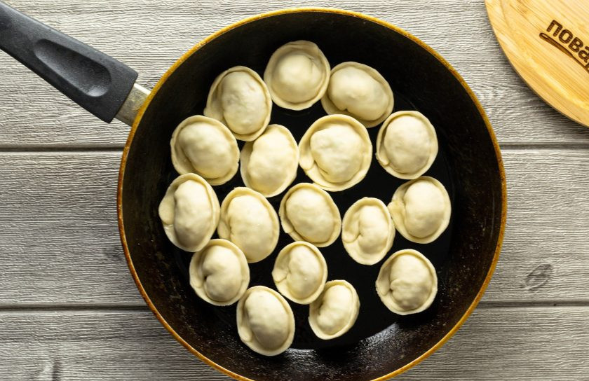 1. Этап. Пельмени с редькой: Разогрейте в сковороде пару ложек растительного масла. Обжарьте пельмени пару минут, затем влейте немного (100-150 мл.) горячей воды, и потушите пельмени под крышкой 6-7 минут до готовности.